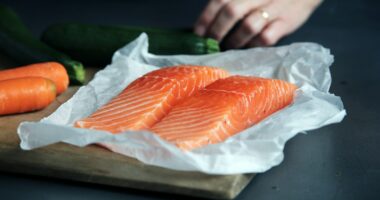 raw fish meat on brown chopping board