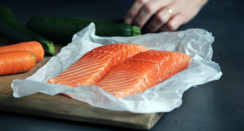 raw fish meat on brown chopping board