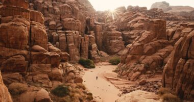 a person walking through a canyon in the desert