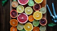 assorted sliced citrus fruits on brown wooden chopping board