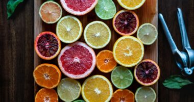 assorted sliced citrus fruits on brown wooden chopping board