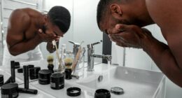 man standing in front of sink