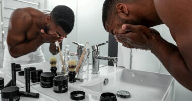 man standing in front of sink