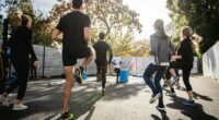 man in black t-shirt and black shorts running on road during daytime