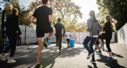 man in black t-shirt and black shorts running on road during daytime