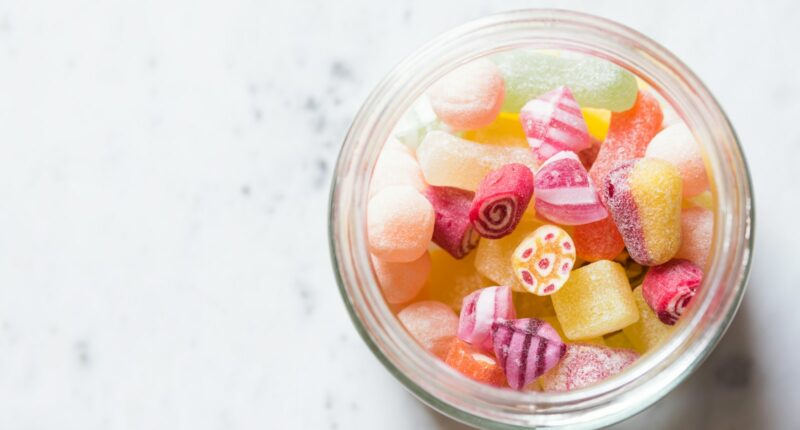 assorted-color candies on container