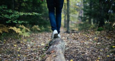 man walking on forest