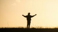 silhouette of person spreading hands